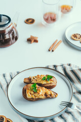 Side view Baked Pears dessert with soft cheese. cinnamon, honey and nuts in the baking form. Delicious autumn dessert. Vertical card. Selective focus, copy space