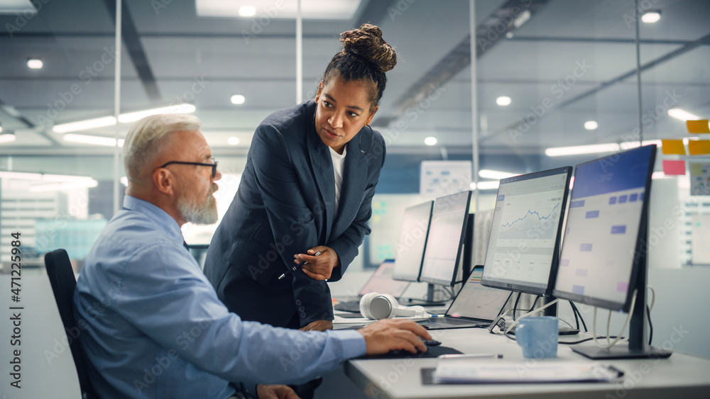 Aufkleber Senior Manager Talking to Experienced Confident Businessman while Using Computer in Modern Office. Colleagues Discuss Commercial, Financial and Marketing Projects. Specialists Work in Diverse Team.