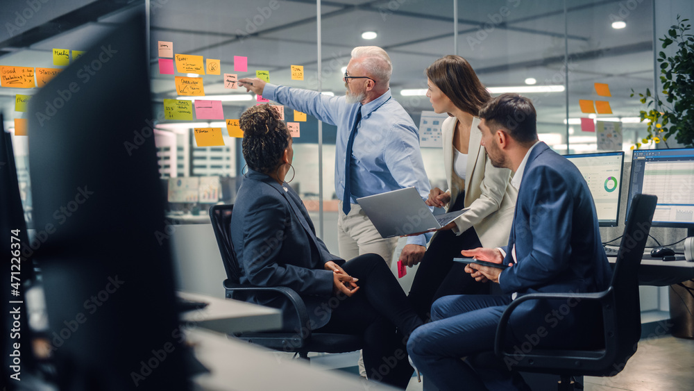 Poster in modern office: diverse team of managers use laptop and tablet computers at a company meeting disc