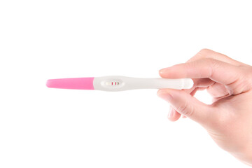 Woman is holding positive pregnancy test on pink background