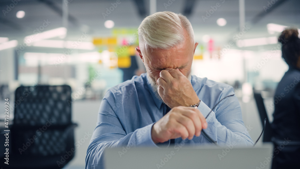 Poster Busy Senior Businessman Using Laptop Computer in Modern Office. Manager Rests His Eyes and Thinks About Successful Financial Ideas. Stressed Man Experienced in Finding Problem Solving Solutions.