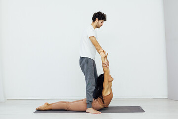 a woman and a man engaged in paired gymnastics yoga asana