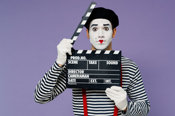 Charismatic amazing vivid young mime man with white face mask wears striped shirt beret holding...