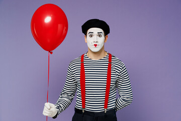 Young mime man with white face mask in striped shirt beret celebrate birthday holiday party hold...