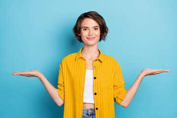 Photo of advertiser lady hands demonstrate empty space wear yellow shirt isolated blue color...