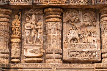 Fototapeta na wymiar Temple platform of Jagamohana carved with erotic couples, young women flaunting their beauty in poses, nagas, vyalas, soldiers, elephants, court scenes Sun Temple Konark, Odisha, India.