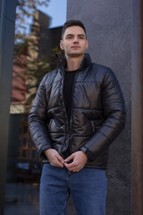 Fototapeta na wymiar Man posing in city wearing winter jacket