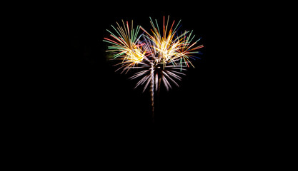 Fototapeta premium Festive fireworks on black background. Colorful celebration. Copy space.