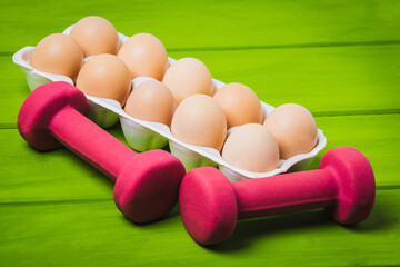 Eggs and a dumbbells, protein for athletes