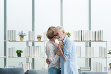 Elderly couple embracing together with romantic in living room.