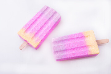 Obraz na płótnie Canvas Multicolored ice cream on a stick. Ice cubes