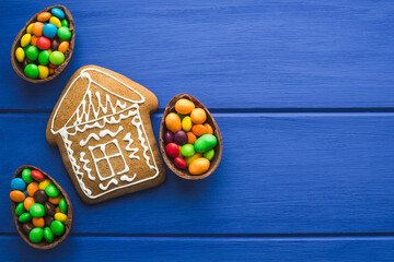 Gingerbread and colored sweets on a blue  wooden background.  Place for text or logo.