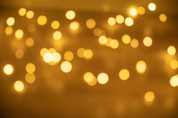 Bokeh golden lights background. Blurred lights festive garland background