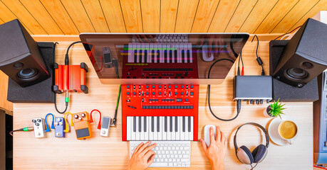 top view of professional music producer, composer hands arranging music on computer and recording...