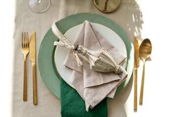 New Year's Eve loft-style table setting with modern golden cutlery. Soft selective focus.