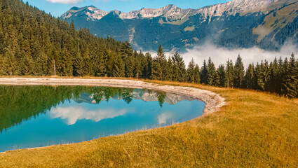 Beautiful alpine summer view with reflections in a pond at the famous Grubigstein summit near Lermoos, Tyrol, Austria