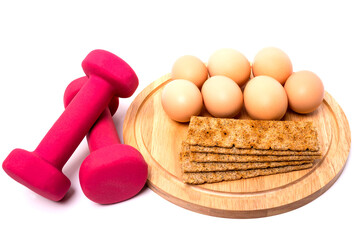 Dumbbell and Eggs , isolated on white background. Concept for healthy supply.