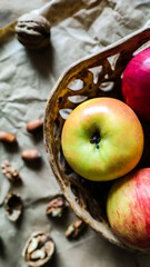 Apples and hazelnuts on the table.