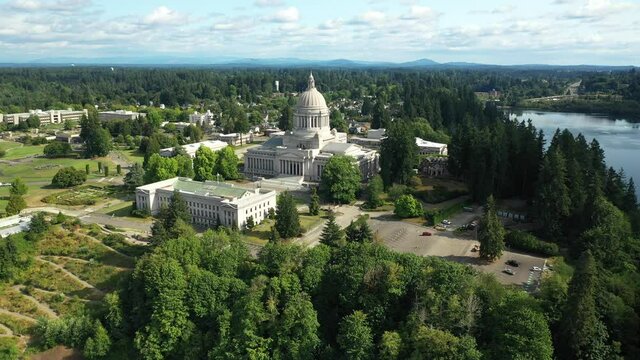 Cinematic 4K aerial drone orbit shot of the Washington State Capitol Building and Campus, Capitol Lake, with a panoramic view of Historic District in Olympia, Washington