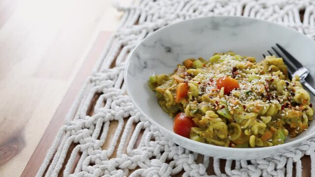vegan pasta with carrots celeri and fresh pesto sauce, healthy plant-based food