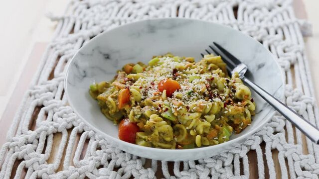 vegan pasta with carrots celeri and fresh pesto sauce, healthy plant-based food
