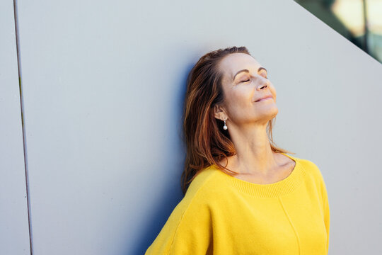 Blissful woman enjoying quality time to relax and de-stress