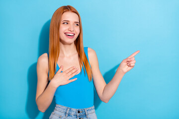 Photo portrait red haired woman showing finger copyspace isolated pastel blue color background