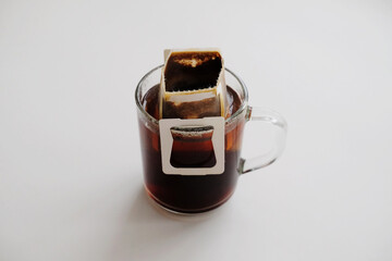 Drip bag coffee on glass cup. Instant freshly brewing method