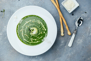 Spinach soup with cream in a bowl. Vegetarian dish. banner, catering menu recipe place for text, top view