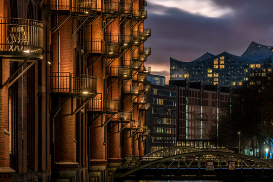 Detailed high dynamic photography of the old and illuminated Speicherstadt in Hamburg, Germany with the new Elbphilharmonie
