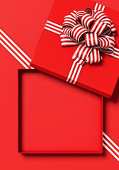 Minimal copy space for Christmas, New year and holiday season. Open red gift box with ribbon bow on red background. 3d render illustration. Clipping path of each element included.