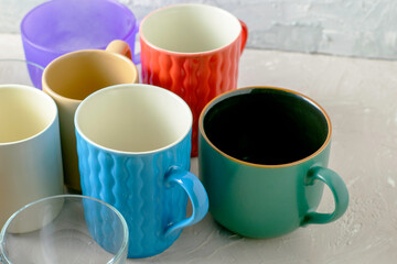 empty mugs of different shapes and sizes on the table
