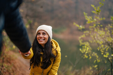 Smiling caucasian woman, experiencing mountain hiking, for the first time.