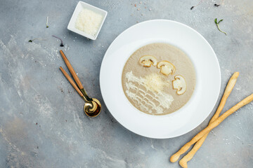 A bowl of delicious homemade cream of mushroom soup. Champignon puree soup, Delicious balanced food concept. banner, catering menu recipe place for text, top view