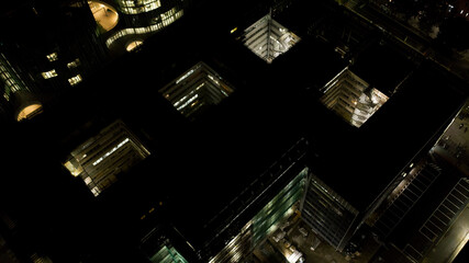 Aerial night view of a courtyard of a building on which overlook the windows and balconies of the condominium
