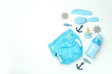 Concept of baby clothes with reusable diapers on white background