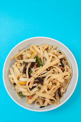 boiled noodle Udon with vegetables on ceramic bowl