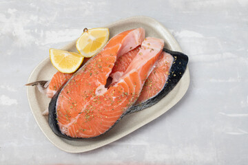 raw salmon with herbs and lemon on dish