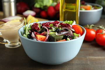 Concept of tasty food with vegetable salad with tahini sauce on wooden background
