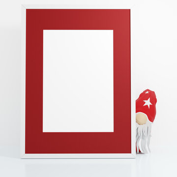 Red vertical empty christmas picture frame with hidden gnome on white table against white wall, 3D render