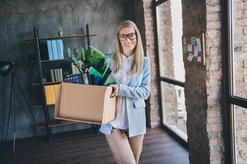 Photo of optimistic representative accountant have first day new work ready meet colleagues hold package in workspace loft