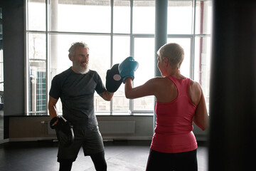 Boxing workout with personal trainer at gym