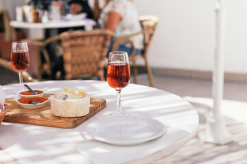 A traditional Portuguese drink Moscatel with cheese, jam and bread on a terrace in a cafe, Portugal 