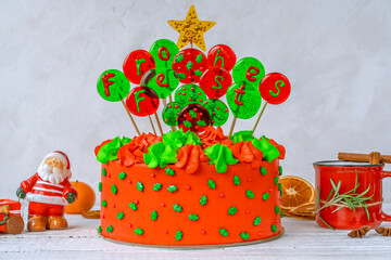 Christmas cake with balls with an inscription in German Frohes Fest Happy holidaya cup of tea with cinnamon and star anise. Decoration for the holiday. Beautifully served table for the celebration.
