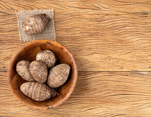 Raw yams or inhames on a bowl over wooden table
