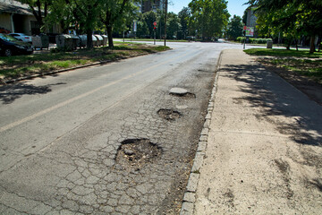 Holes in the asphalt road