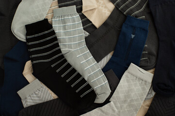 Men's socks in abundance. Many men's socks are folded as a background. Men's socks in different colors.