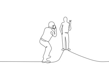 man makes a photo of a friend on the phone - one line drawing vector. concept mobile vertical photo, posing for a photo with the sign "peace"