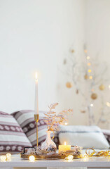 christmas home decorations with candles in white interior