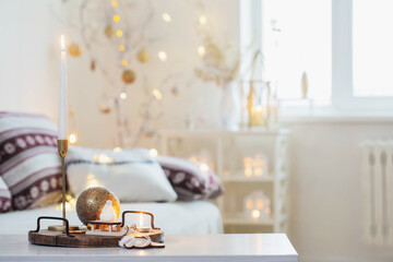christmas home decorations with candles in white interior